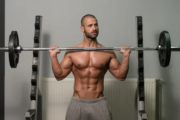 Bodybuilder Exercising Shoulders With Barbell — Stock Photo, Image