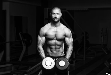 Vücut geliştirmeci omuz Dumbbells ile egzersiz
