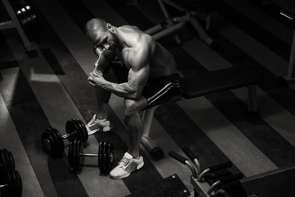 Gesunder junger Mann ruht sich in Fitnessstudio aus — Stockfoto