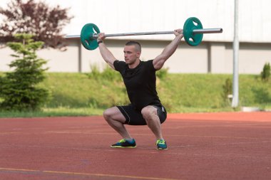 Young Man Doing A Overhead Squat Exercise Outdoor