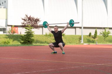 Young Man Doing A Overhead Squat Exercise Outdoor