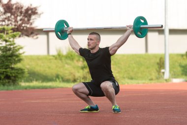 Young Man Doing A Overhead Squat Exercise Outdoor