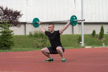 Young Man Doing A Overhead Squat Exercise Outdoor