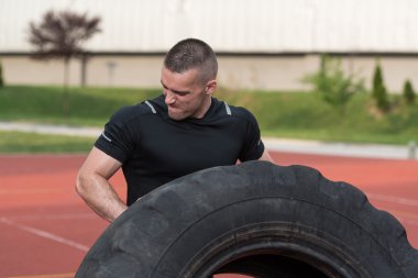 Young Man Doing Tire Workout Outdoor