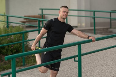 Young Sportive Man Doing Gymnastics Outdoors