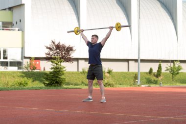 Young Man Doing A Overhead Squat Exercise Outdoor