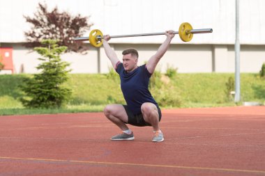 Young Man Doing A Overhead Squat Exercise Outdoor