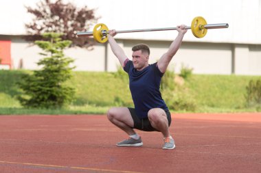 Young Man Doing A Overhead Squat Exercise Outdoor