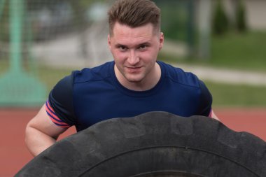 Young Man Doing Tire Workout Outdoor