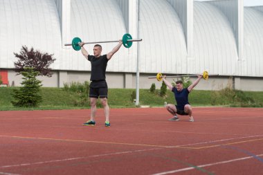 Young People Doing A Overhead Squat Exercise Outdoor