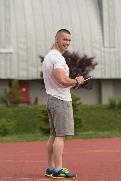 Porträt eines männlichen Trainers mit Klemmbrett im Freien — Stockfoto