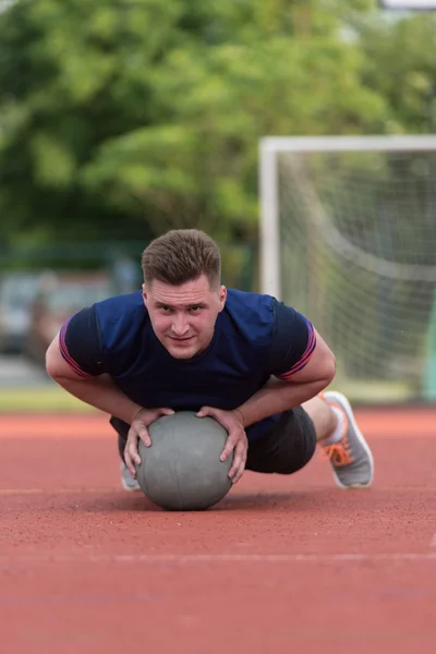 Young Man Exercising Push-Ups On Medicine Ball Outdoor — Stock Photo, Image