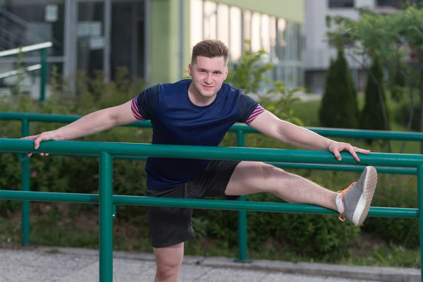 Young Man Is Streching Outdoors — Stock Photo, Image