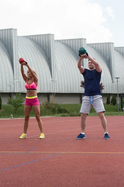 Young People Doing Kettle Bell Exercise Outdoor — Stockfoto