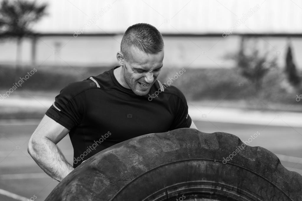 Young Man Turning Tires Outdoor