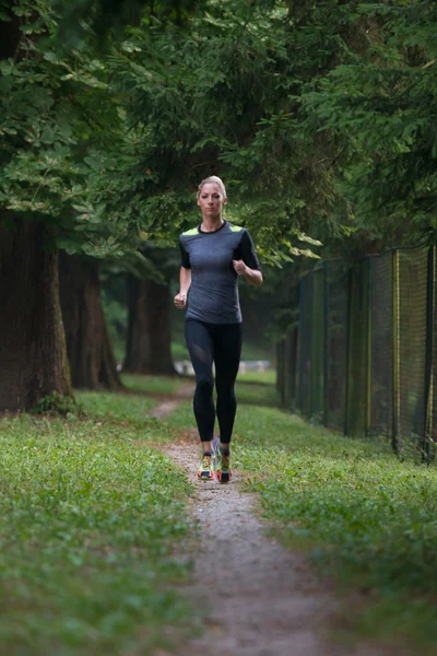 Woman Runner Running Through The Spring Park Road — Stock Photo, Image