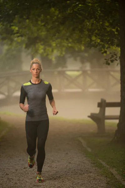 Woman Runner Running Through The Spring Park Road — Stock Photo, Image