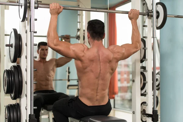 Bodybuilder Exercising Shoulders With Barbell — Stock Photo, Image