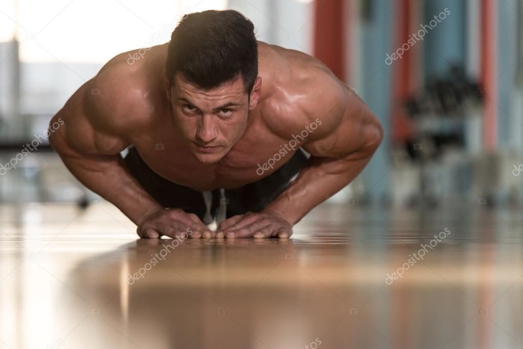 Young Man Doing Press Ups In Gym