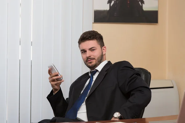 Manier inzakenman praten op telefoon in office — Stockfoto