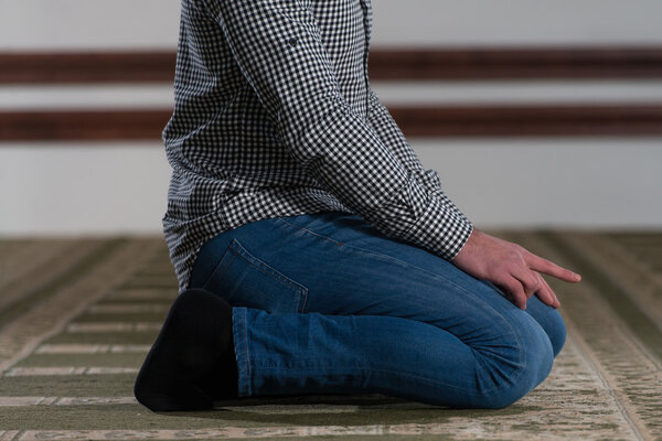 Close-Up Of Male Hands Praying In Mosque