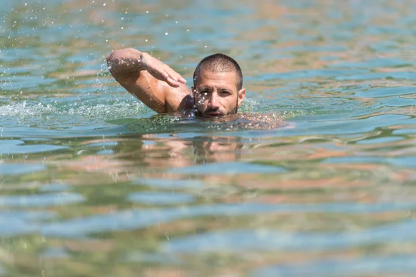 Young Man Swimming In Green Water — Stock Photo, Image