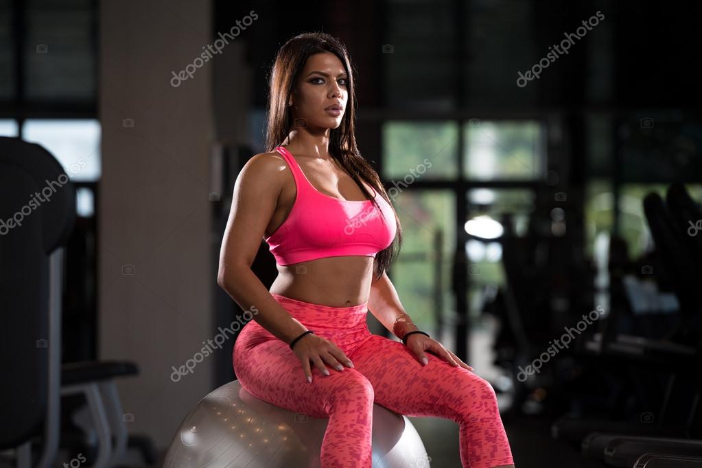 Sexy Latino Woman Resting After Workout In Gym Stock Photo Sexy Latino Woman Resting After Workout In Gym Stock Photo