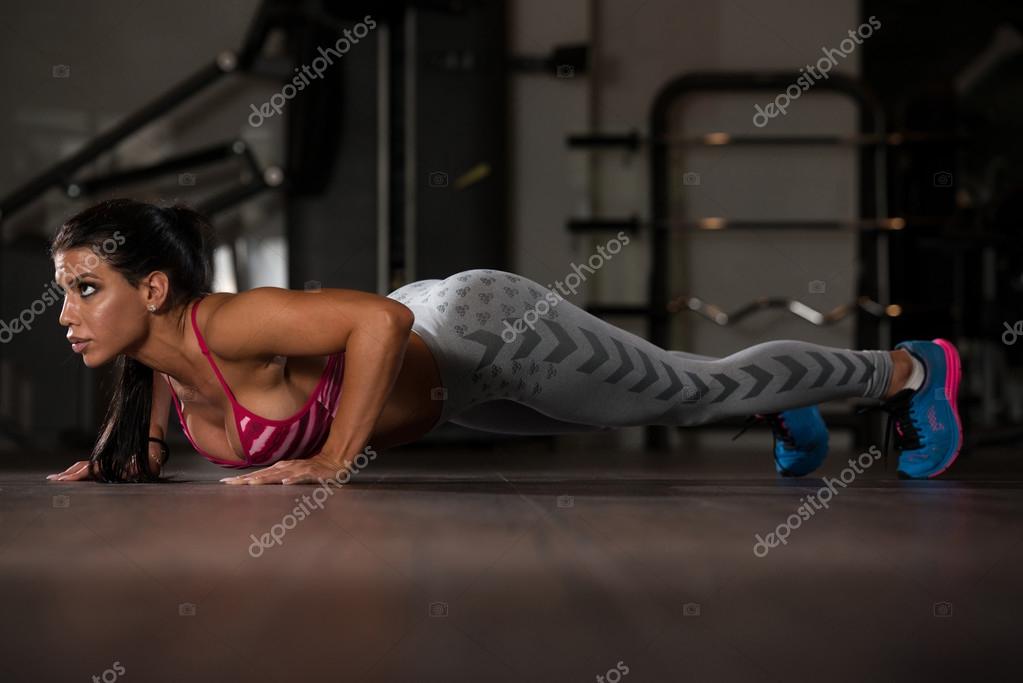Sexy Woman Doing Push Ups On Floor Stock Photo by ©ibrak 94431696