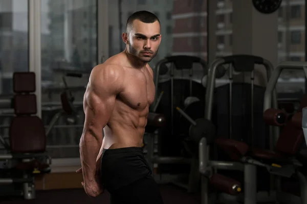 Young Man Performing Side Triceps Pose — Stock Photo, Image