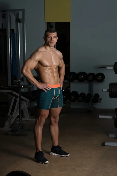 Homem no ginásio mostrando seu corpo bem treinado — Fotografia de Stock