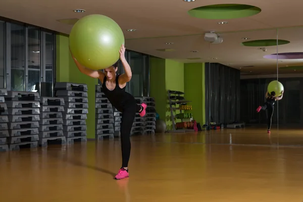 Frau trainiert mit Ball im Fitnessstudio — Stockfoto