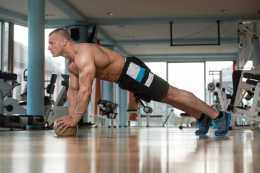 Basın yapan genç erkek Fitness topu üzerinde Ups