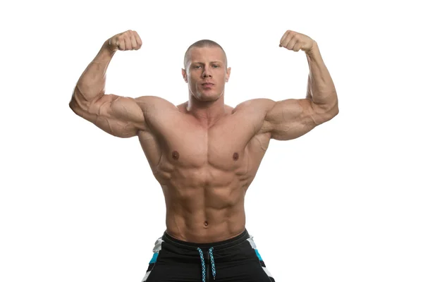 Fisiculturista e duplo bíceps dose sobre fundo branco — Fotografia de Stock