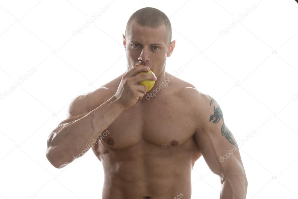 Bodybuilder Eating A Apple Isolated On White Background