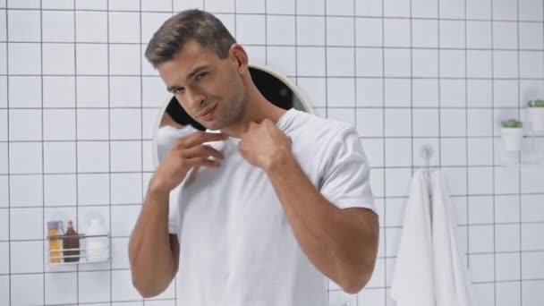 Musculoso Hombre Quitándose Camiseta Blanca Lanzando Mientras Mira Cámara — Vídeos de Stock