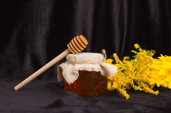 Bee Honey Glass Jar Lid Wooden Spatula Yellow Flowers Black — Stock Photo, Image