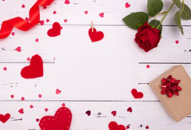 Beyaz ahşap arka planda hediye, gül ve kırmızı kalpler, üst manzara. Copyspace, Sevgililer Günü konsepti.