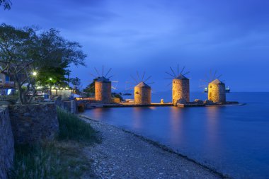 Ancient windmills of chios at night clipart