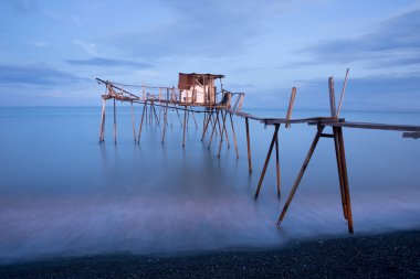 İskele ve pürüzsüz okyanus güneş doğarken, eski ahşap iskele Balık tutma