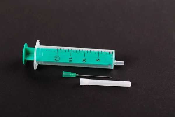 Green plastic syringe — Stock Photo, Image