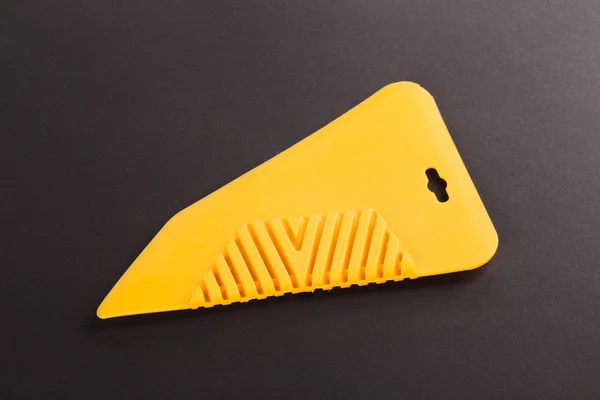 Yellow rubber industrial spatula — Stock Photo, Image