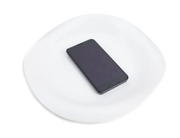 Modern mobile phone on a plate. — Stock Photo, Image