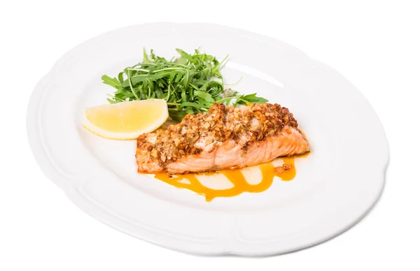 Baked salmon fillet with walnuts and arugula. — Stock Photo, Image