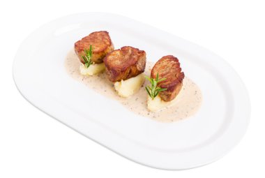 Kızarmış domuz eti bonfile madalyonlar patates püresi üzerinde.