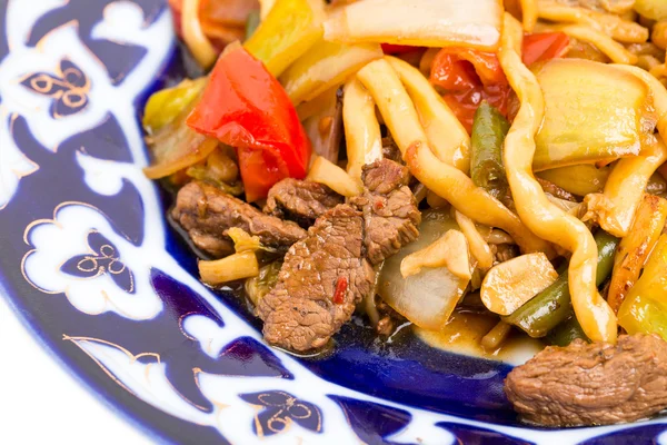 Baked lamb with noodles and stewed vegetables.