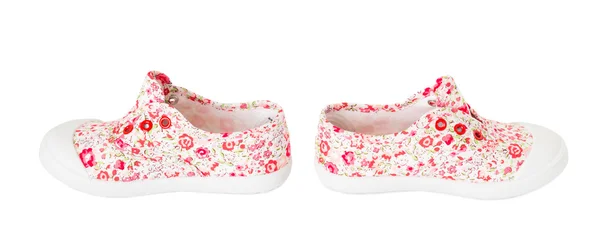 Baby flicka rosa sneakers med blommönster. — Stockfoto