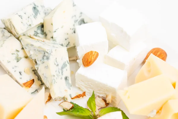 Assorted cheese platter with almonds closeup. — Stock Photo, Image