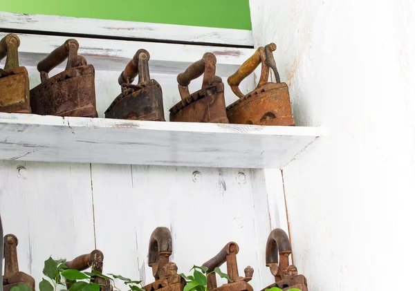 Old rusty irons on wooden boards. — Stock Photo, Image