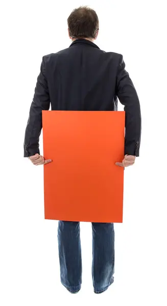 Hombre sosteniendo hoja de cartón naranja . — Foto de Stock