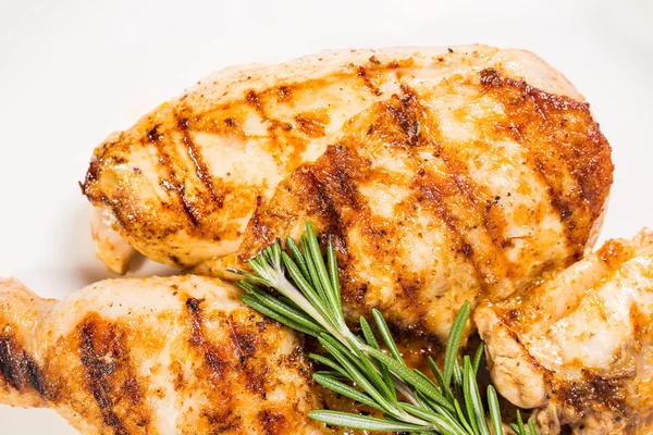 Grilled chicken fillet and legs with rosemary.